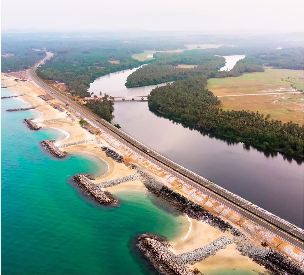 Aerial view of Maravanthe, where National Highway 66 runs on a narrow strip between the Arabian Sea and the Souparnika river near Kundapura