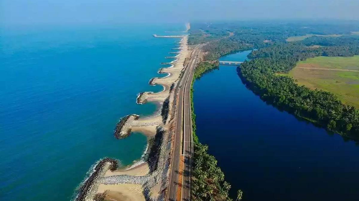 Aerial view of Maravanthe with sculpted sandy bays between rock groynes, the highway and a bridge over the Souparnika river