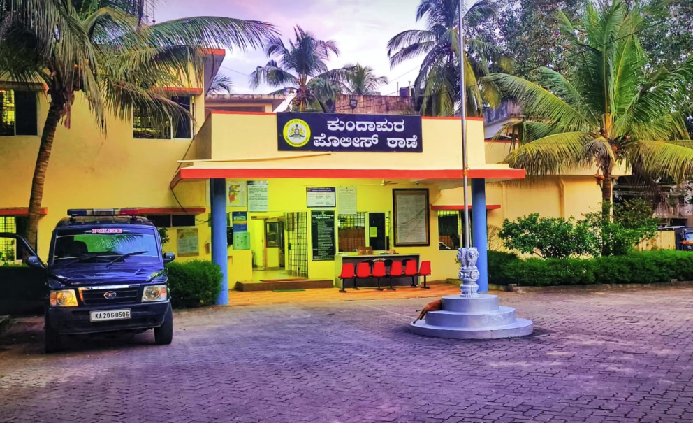 The Kundapura Police Station — a yellow building with a red-roofed porch, a police jeep parked outside and the station name in Kannada