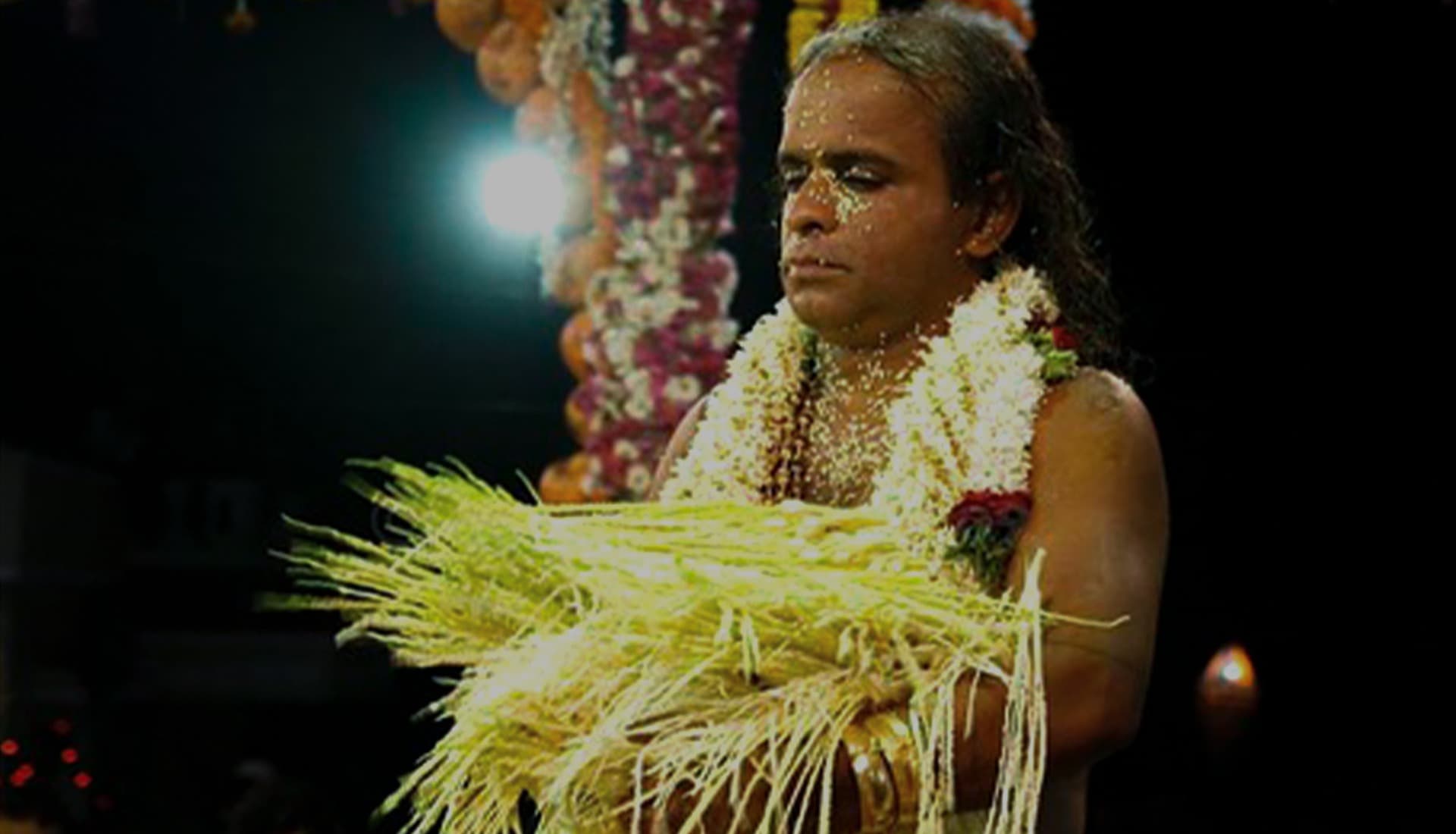 A Naga Mandala performer in serpent costume during the ritual