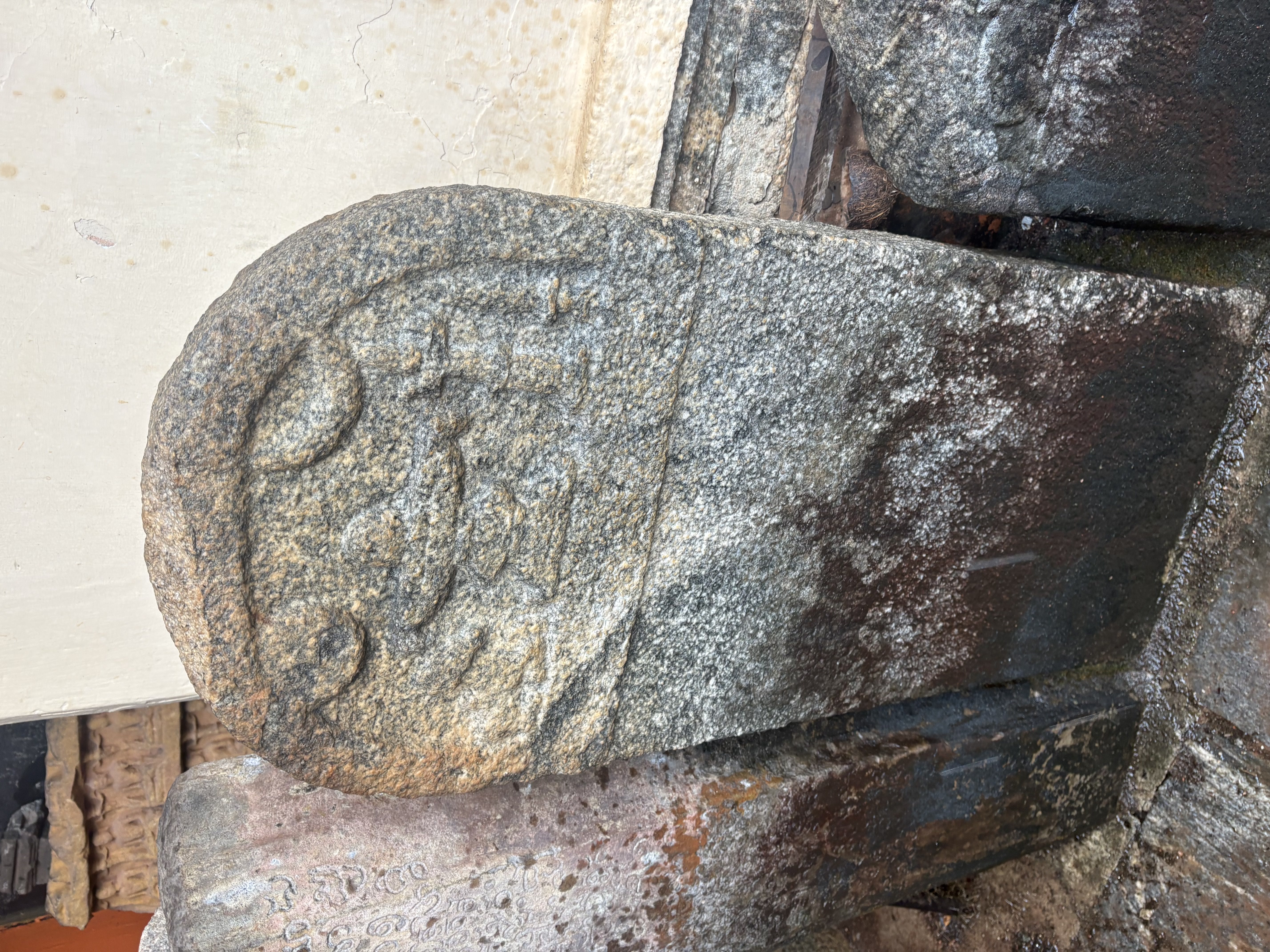A memorial stone topped with a linga relief