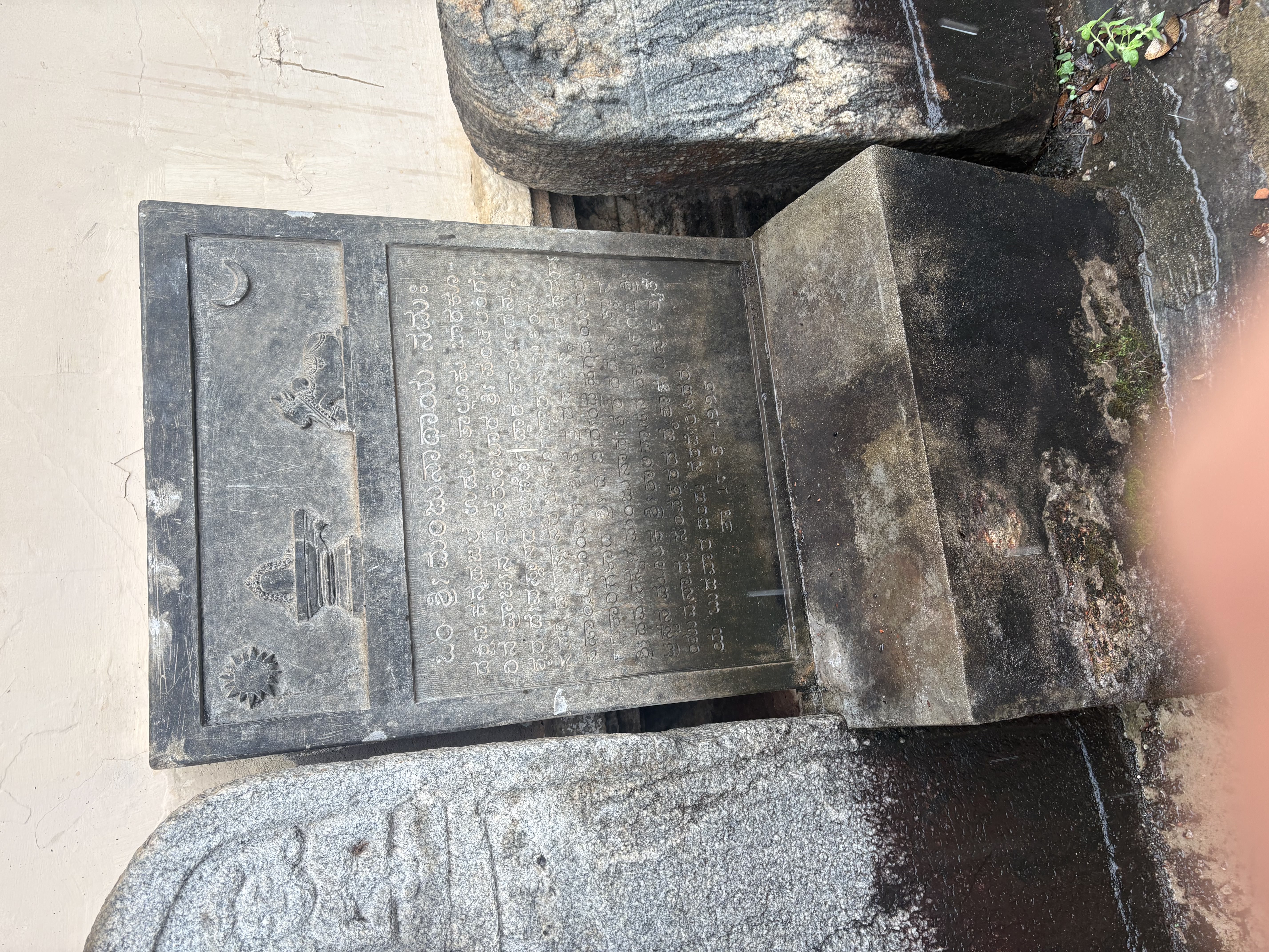 A rounded hero-stone, its panel worn away