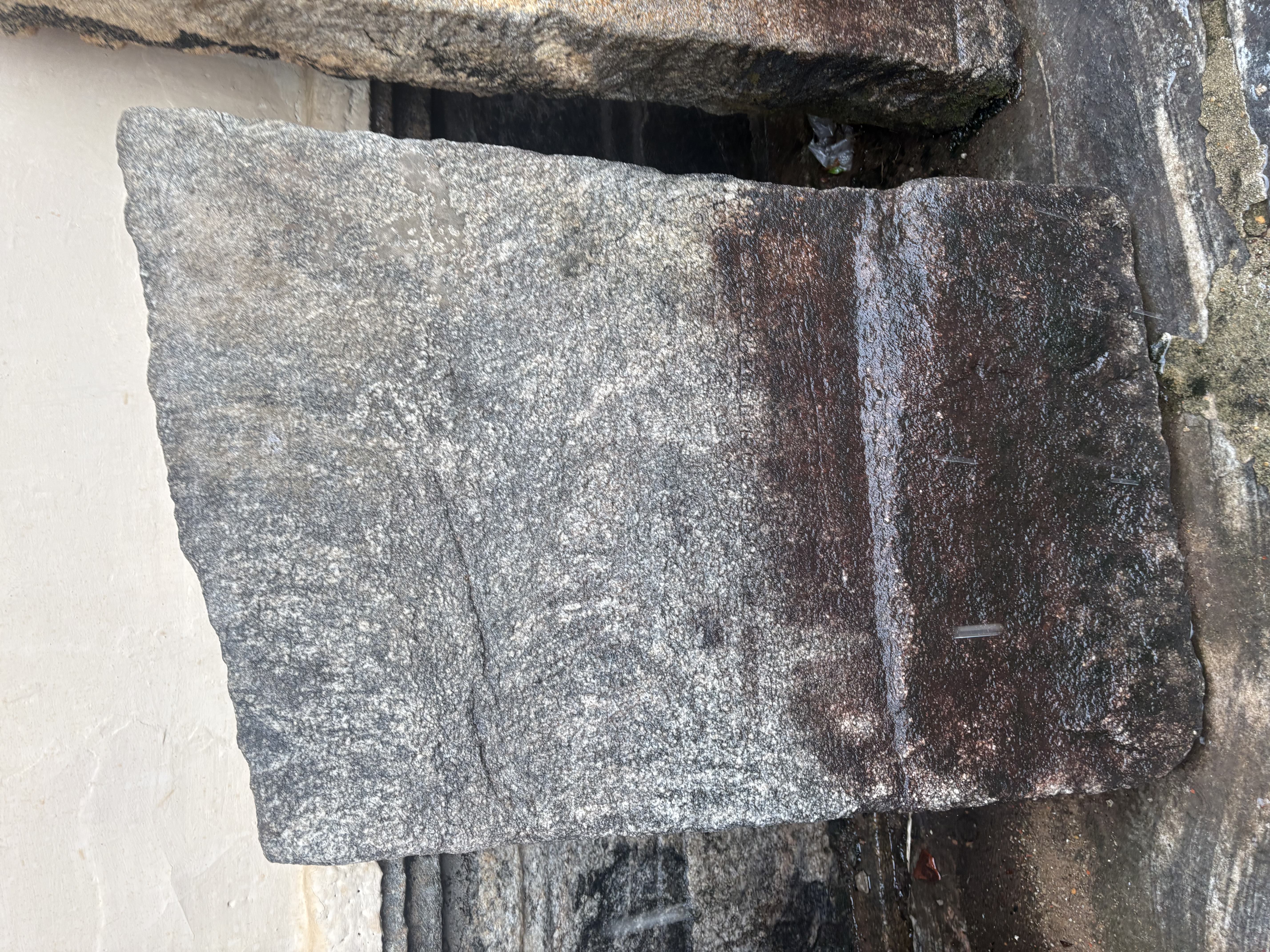 An arched memorial stone with a faint relief